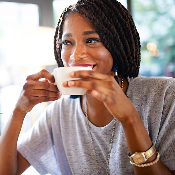 smiling woman drinking coffee