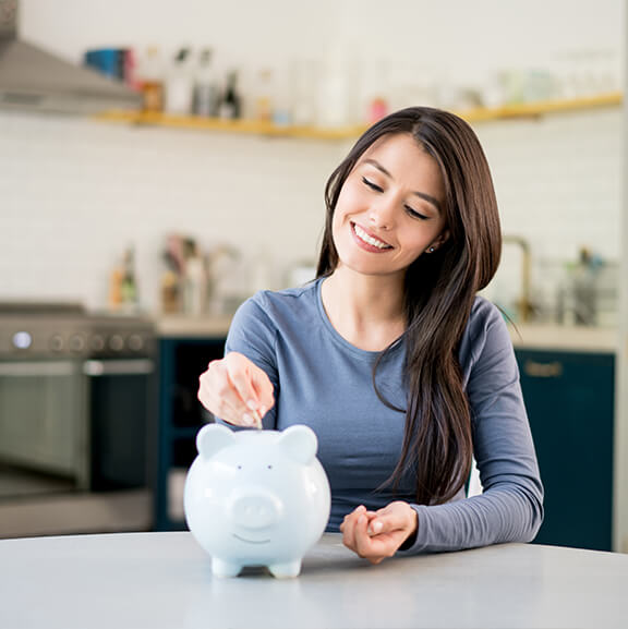 woman saving money in piggy bank