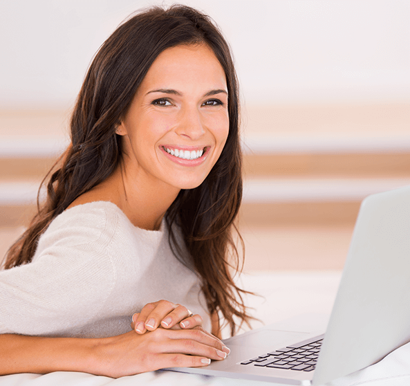 woman with computer smiling