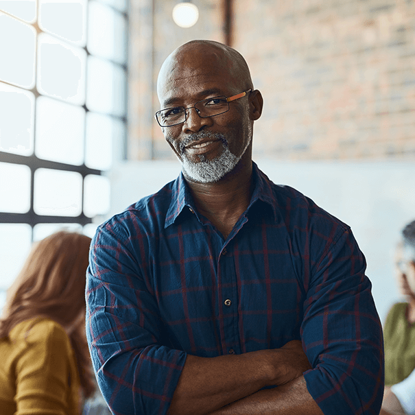 man with crossed arms smiling