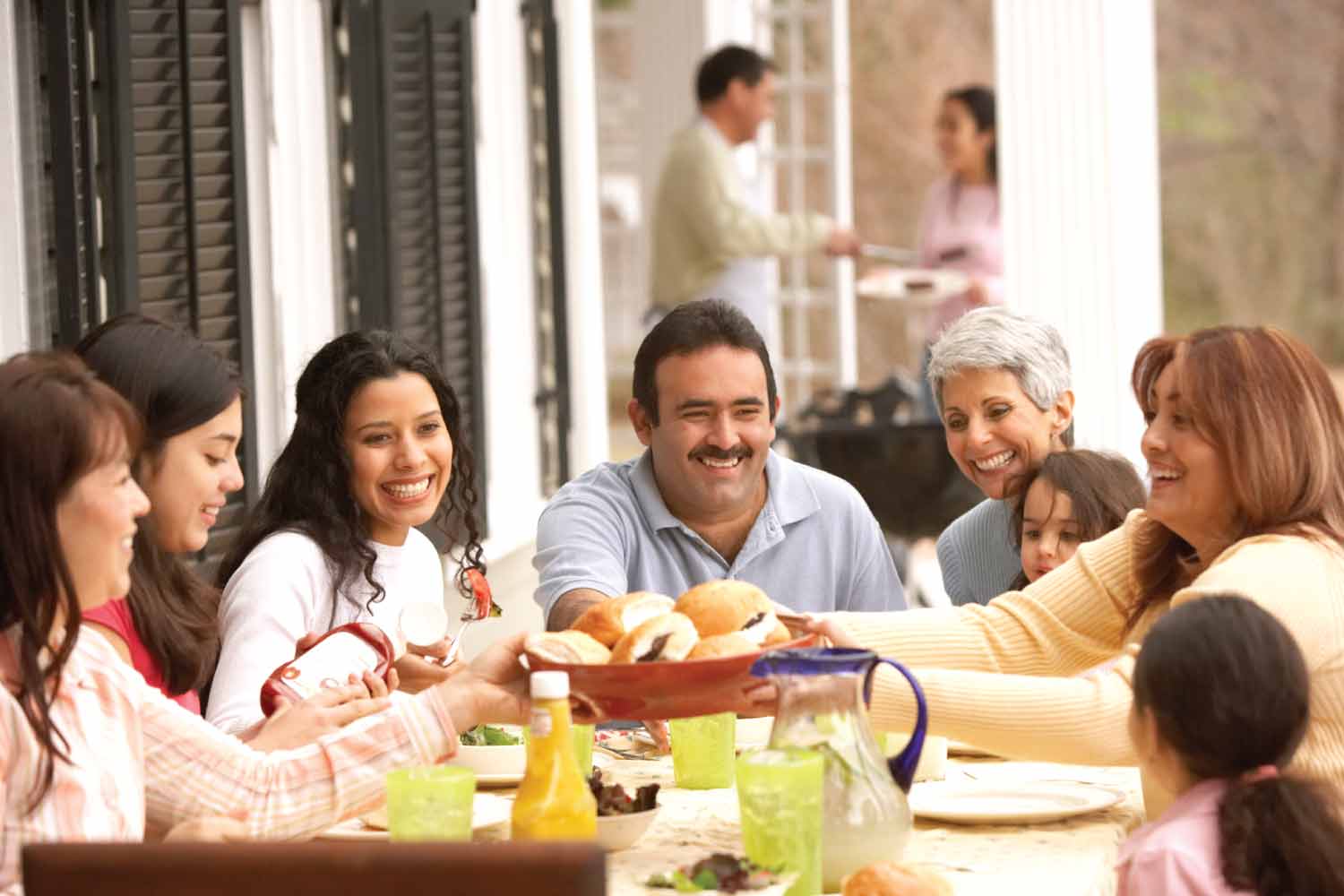 Hispanic family eating outside together.
