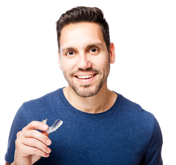 man holding clear aligner