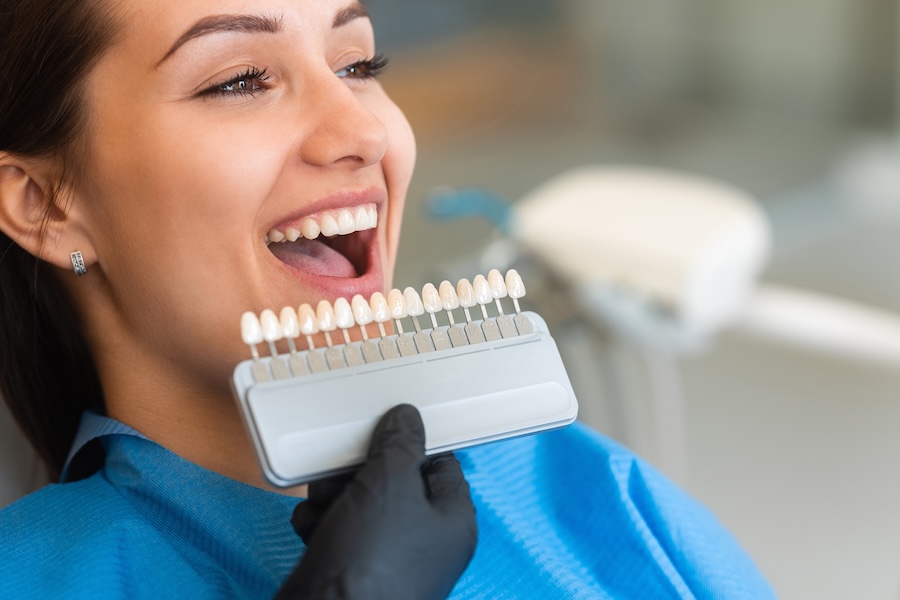 woman getting teeth whitening wondering does teeth whitening damage enamel?